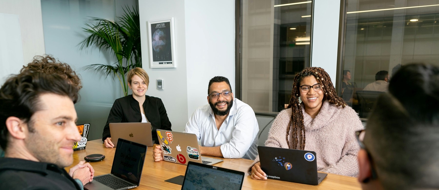 group of professionals sit around a conference table