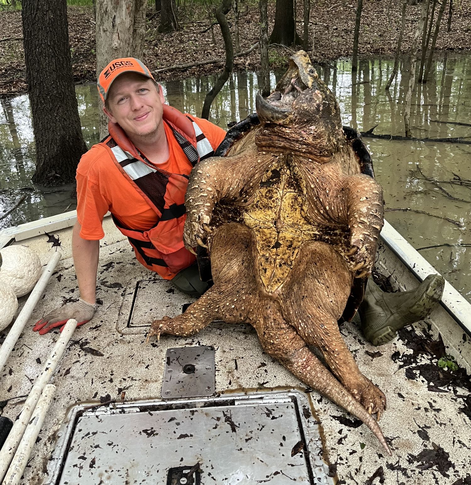 Brad Glorioso on a boat with a huge turtle