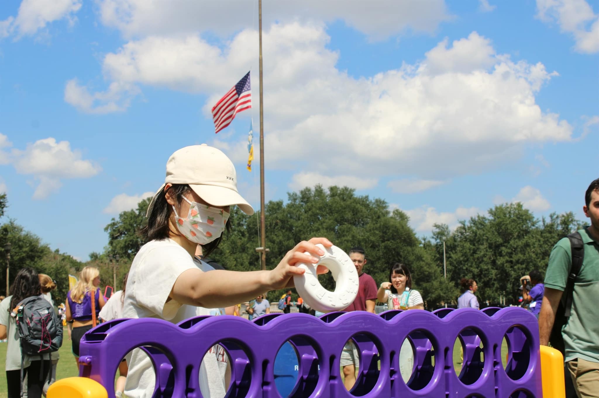 Student playing large connect 4 game at Fall Fest