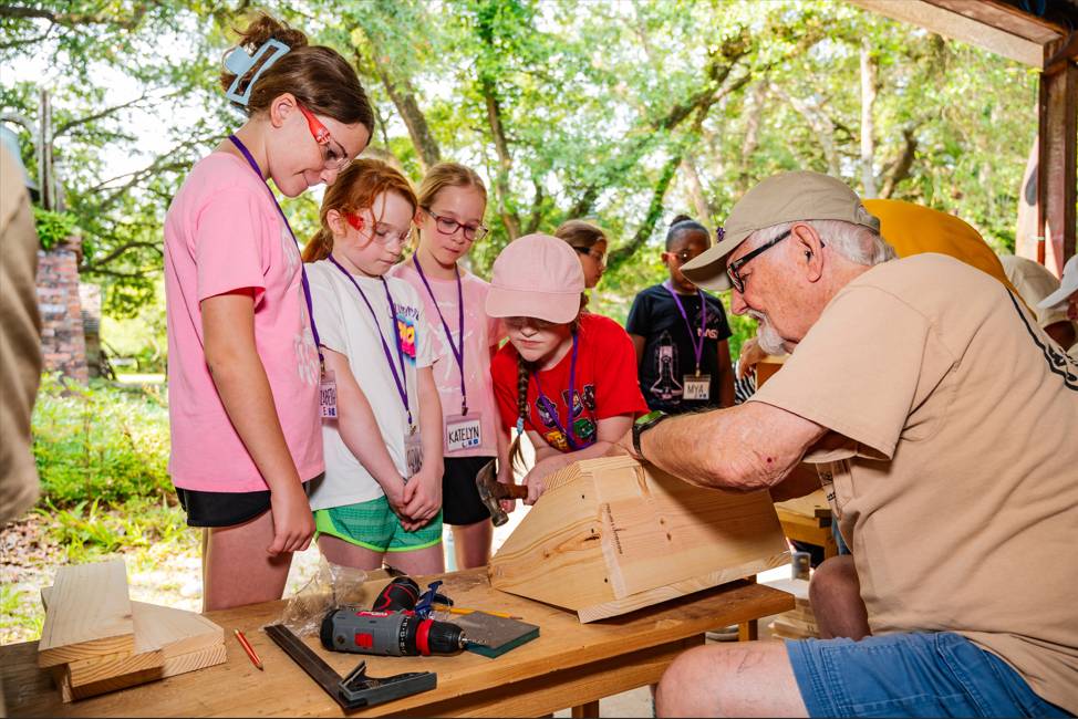Campers building a birdhouse