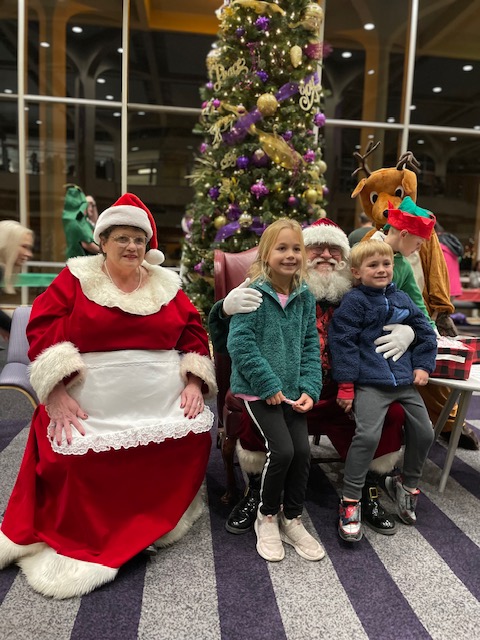 Santa Claus and Mrs. Claus with children